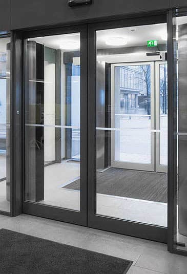 Dark KONE automatic sliding doors at Aava health service centre.